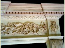 Work in progress on bespoke fire surround featuring carved instruments.